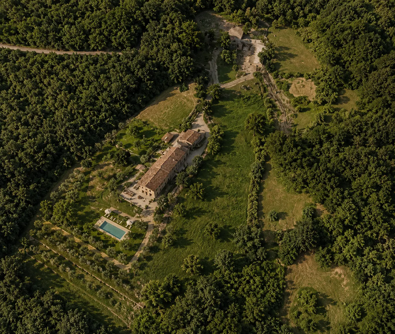 Aerial view of an estate surrounded by woodland